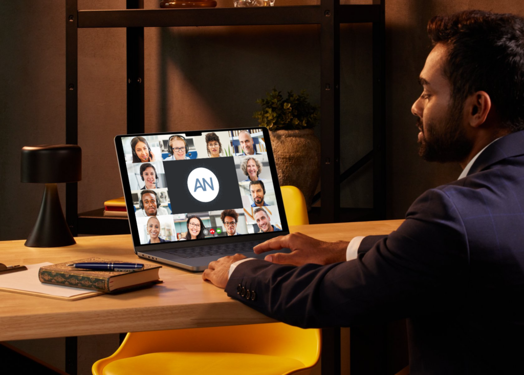 Man using his laptop during a virtual meeting with a group, relying on Ari to capture accurate meeting minutes