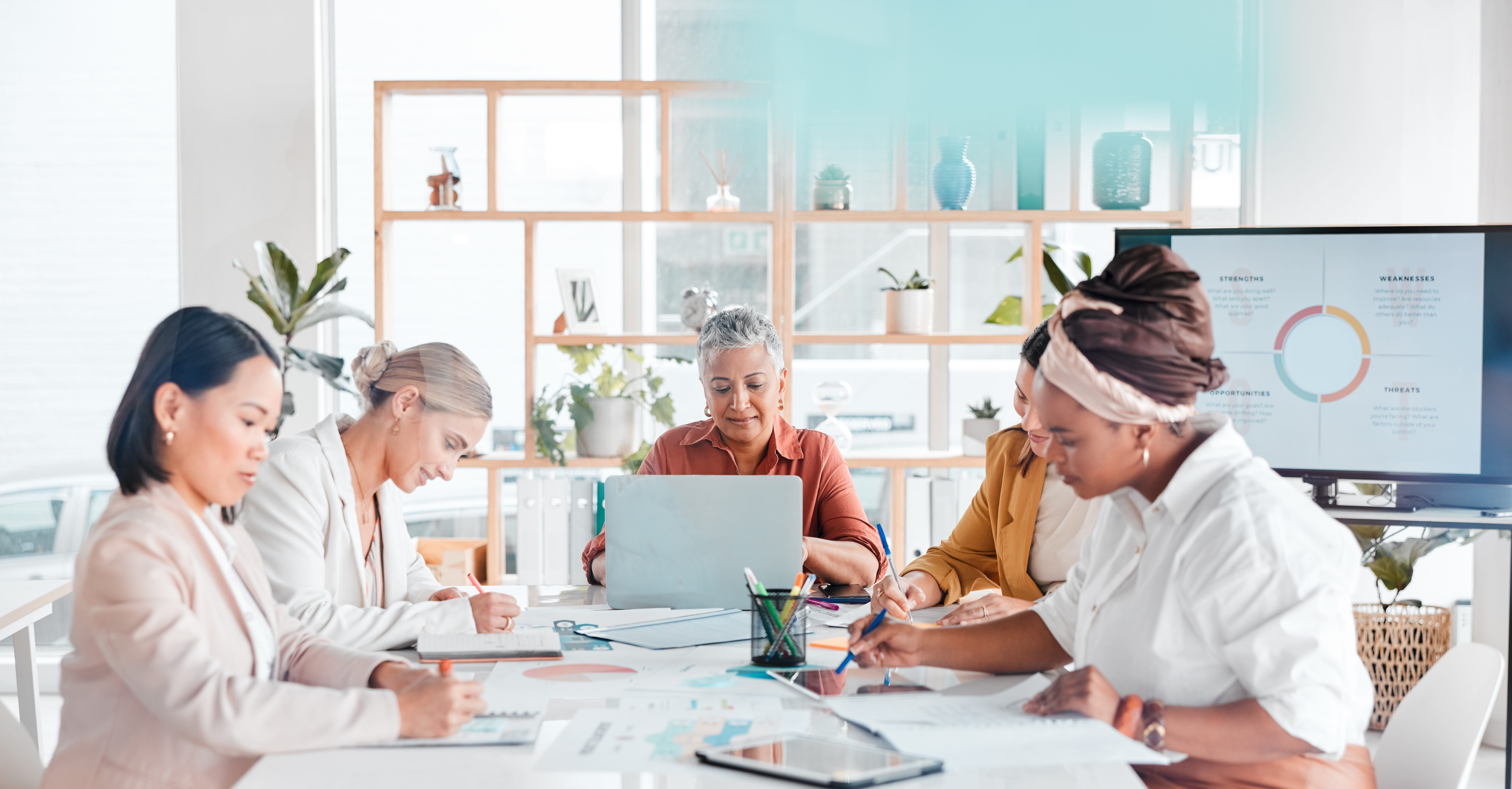 Team members are working in office to achieve business goals